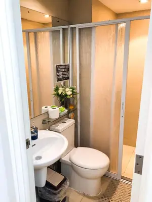 a bathroom with a toilet and a sink at 1Bedroom Beach View with Netflix near Airport in Manila