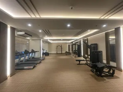 a gym with treadmills and exercise equipment in a building at Vincondotel Near BGC 3BR Fairlane in Manila