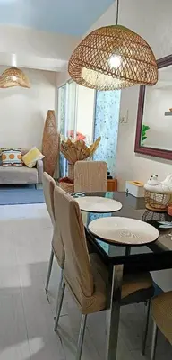 a dining room with a table and chairs at Azure Urban Residences By Lyn 2BR in Manila