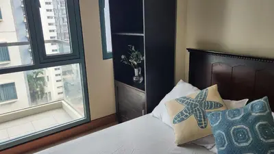 a bedroom with a bed and a window at Casa Antonio at 7i Two Palm Tree Villas Beside NAIA3 in Manila