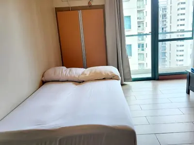 a bed in a room with a large window at Casa Antonio at 7i Two Palm Tree Villas Beside NAIA3 in Manila