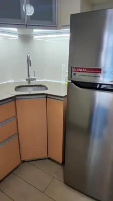 a kitchen with a sink and a stainless steel refrigerator at Casa Antonio at 7i Two Palm Tree Villas Beside NAIA3 in Manila