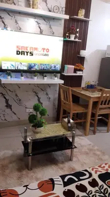 a living room with a table and a chair and a table and a tableablish at 3M Staycation in Manila
