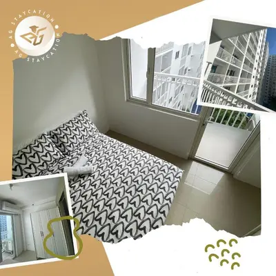 a small room with a bed and a window at 1br with Balcony near MOA unit 3 in Manila