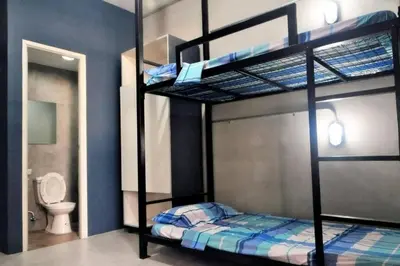 a bedroom with two bunk beds and a toilet at Manila Real Residences 8A in Manila