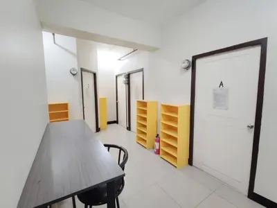a conference room with a wooden table and chairs at Manila Real Residences 8A in Manila