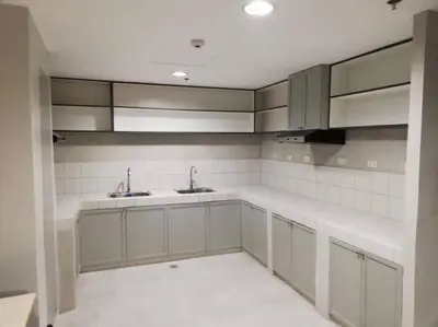 a kitchen with white cabinets and sinks in it at Manila Real Residences 8C in Manila