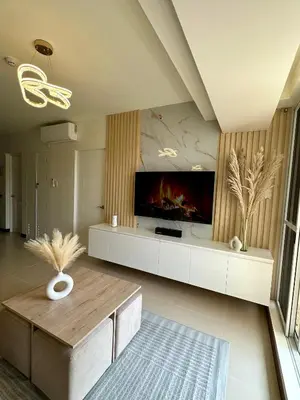 a large living room with a large tv and a table at Condo in Taguig in Manila