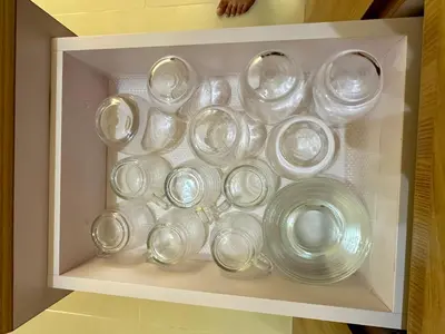 a drawer filled with glass dishes in a white box at Condo in Taguig in Manila