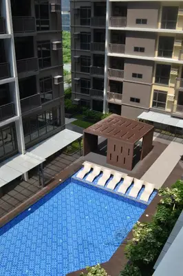 a swimming pool in the middle of a apartment building at Gentry Manor Family Suite Facing Okada Fountain WiFi Netflix Near Airport 8A in Manila