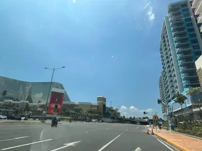 an empty street in a city with tall buildings at Gentry Manor Family Suite Facing Okada Fountain WiFi Netflix Near Airport 8A in Manila