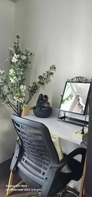 a desk with a chair and a mirror and flowers at Relaxing Chic Hotel Like with Manila Bay view in Manila