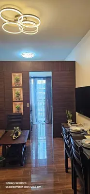 a dining room with a table and a chandelier at Relaxing Chic Hotel Like with Manila Bay view in Manila