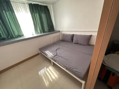 a small bed in a room with a window at RKChillescapes in Manila