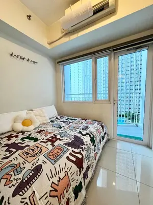 a bedroom with a bed with a colorful blanket at Fun Pop-Art Inspired Makati Studio in Manila