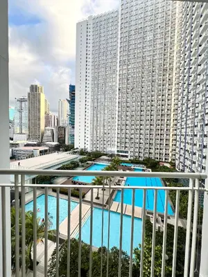 a view of a large building with a swimming pool at Fun Pop-Art Inspired Makati Studio in Manila