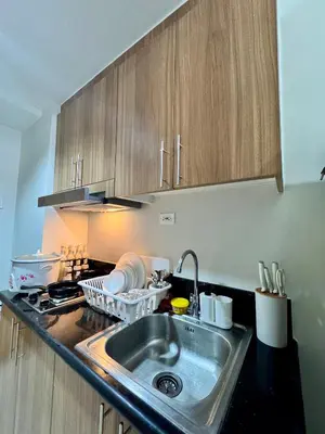 a kitchen with a sink and a counter top at Hearth of Ember at Shore 3 in Manila