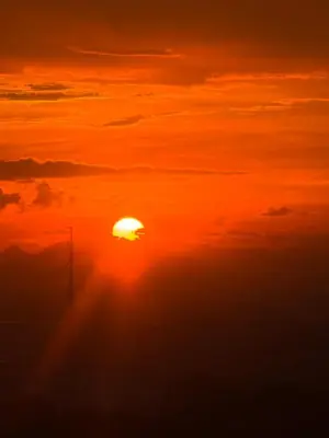 an orange sunset with the sun in the sky at Green 2 SMDC - STUDIO TYPE Condo - Gems Suite Staycation in Dasmariñas