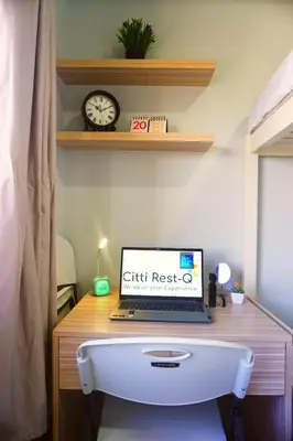 a laptop computer sitting on top of a wooden desk at Studio City Alabang Pool Access Free for 2 Wifi & Netflix SC1 in Manila