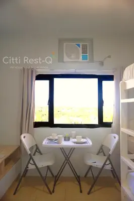 a table and chairs in a room with a window at Studio City Alabang Pool Access Free for 2 Wifi & Netflix SC1 in Manila