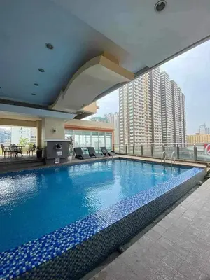 a large swimming pool on top of a building at Birch Tower Malate Accommodation by T&T in Manila