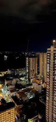 a night view of a city with tall buildings at Birch Tower Malate Accommodation by T&T in Manila