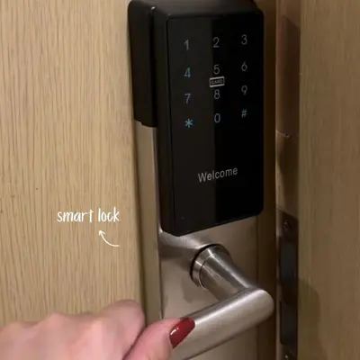 a person unlocking a door with a smart lock at Cozy Stay Near BGC & Airport in Manila