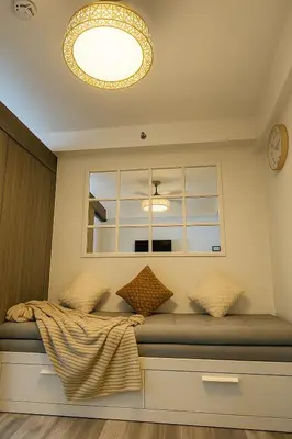 a room with a window and a bed with pillows at La Casa de Maria in Manila