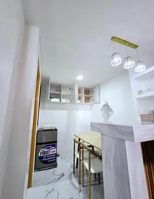 a kitchen and dining room with a table and a television at Tiny home in Naic in Naic