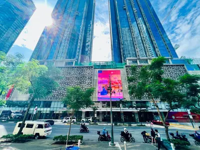 a tall building with people riding motorcycles in front of it at BGC High Rise, Uptown Mall Connector, 5G WiFi, Pool, Ste 15 in Manila