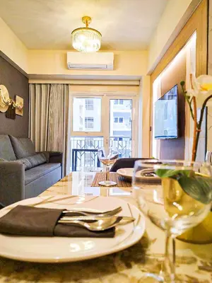 a dining room with a table with a plate and glasses at Cozy 3BR near Airport and Okada in Manila