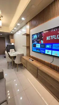 a waiting room with a television on a wall at Shore 3 staycation in Manila