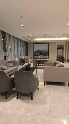 a large living room with couches and tables in a building at Shore 3 staycation in Manila