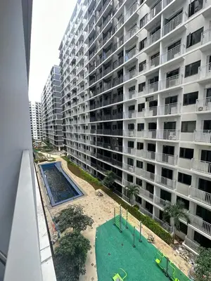 an apartment building with a playground in front of it at Shore 3 staycation in Manila