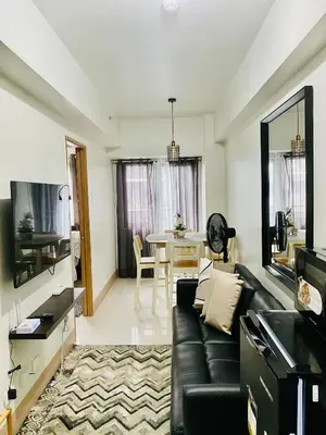 a living room with a couch and a table at SMDC Shore 3 Residences in Manila