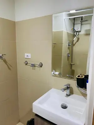 a bathroom with a sink and a mirror at SMDC Shore 3 Residences in Manila