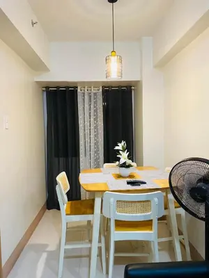 a dining room with a table and chairs at SMDC Shore 3 Residences in Manila