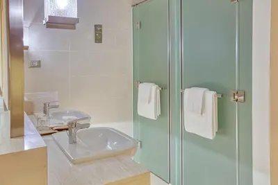 a bathroom with a sink and a shower at Amira Luxury at Novotel Suites Manila near Makati and BGC in Manila