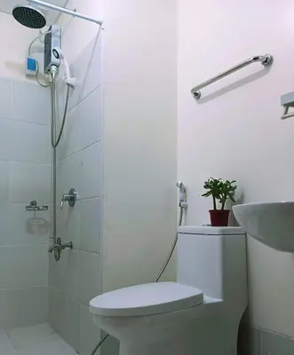 a bathroom with a shower and a toilet and a sink at 2BR Pioneer Woodland connected to Metro Rail Station SM Light,BONI Mandaluyong, Metro Manila,Philippines in Manila