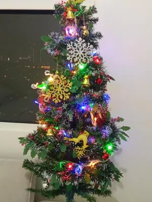 a christmas tree with colorful lights on it at 1BR Covent Garden South Tower University Belt- SM Sta Mesa, Metro Manila,Philippines in Manila