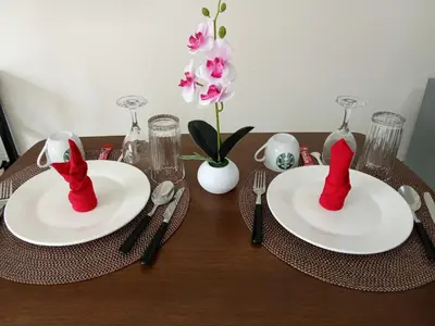 a table with two plates with red socks on them at 1BR Covent Garden South Tower University Belt- SM Sta Mesa, Metro Manila,Philippines in Manila
