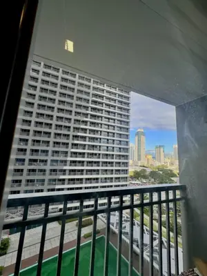 a view of a tall building from a balcony at Reden Staycation in Manila