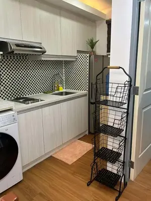 a kitchen with a dishwasher and a dish drying rack at Away from but close like family room in Manila