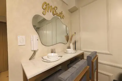 a dining room with a table and a mirror at GM Suite near SM MOA, Pasay I 2 Beds I City & Bay View in Manila