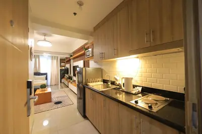 a kitchen with a sink and a counter top at GM Suite near SM MOA, Pasay I 2 Beds I City & Bay View in Manila