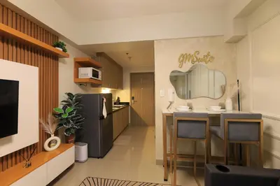 a kitchen with a table and a counter top at GM Suite near SM MOA, Pasay I 2 Beds I City & Bay View in Manila