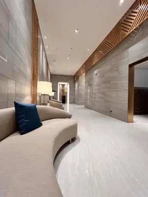 a living room with a couch and a blue pillow at Condo Ortigas CBD in Manila