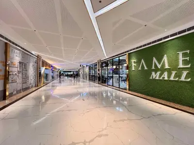 an empty hallway in a mall with a green wall at Condo Ortigas CBD in Manila