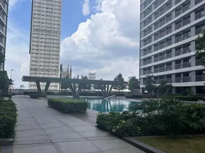 a bench in the middle of a city with buildings at SMDC Apartment Ortigas in Manila
