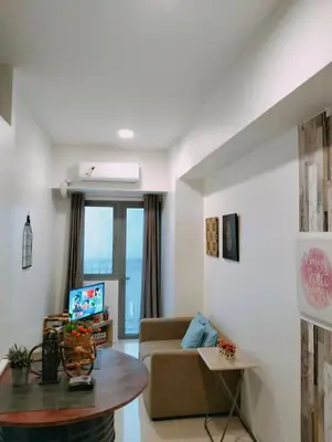 a living room with a couch and a table at SMDC Apartment Ortigas in Manila